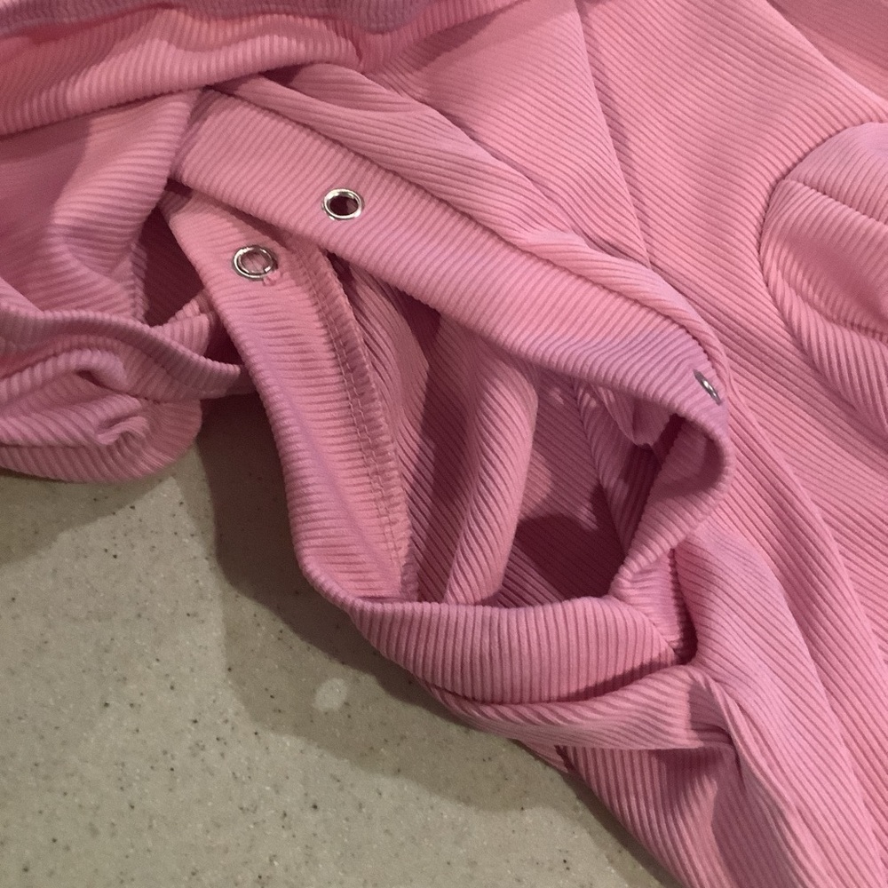 Two different colored pairs of shorts and shirts